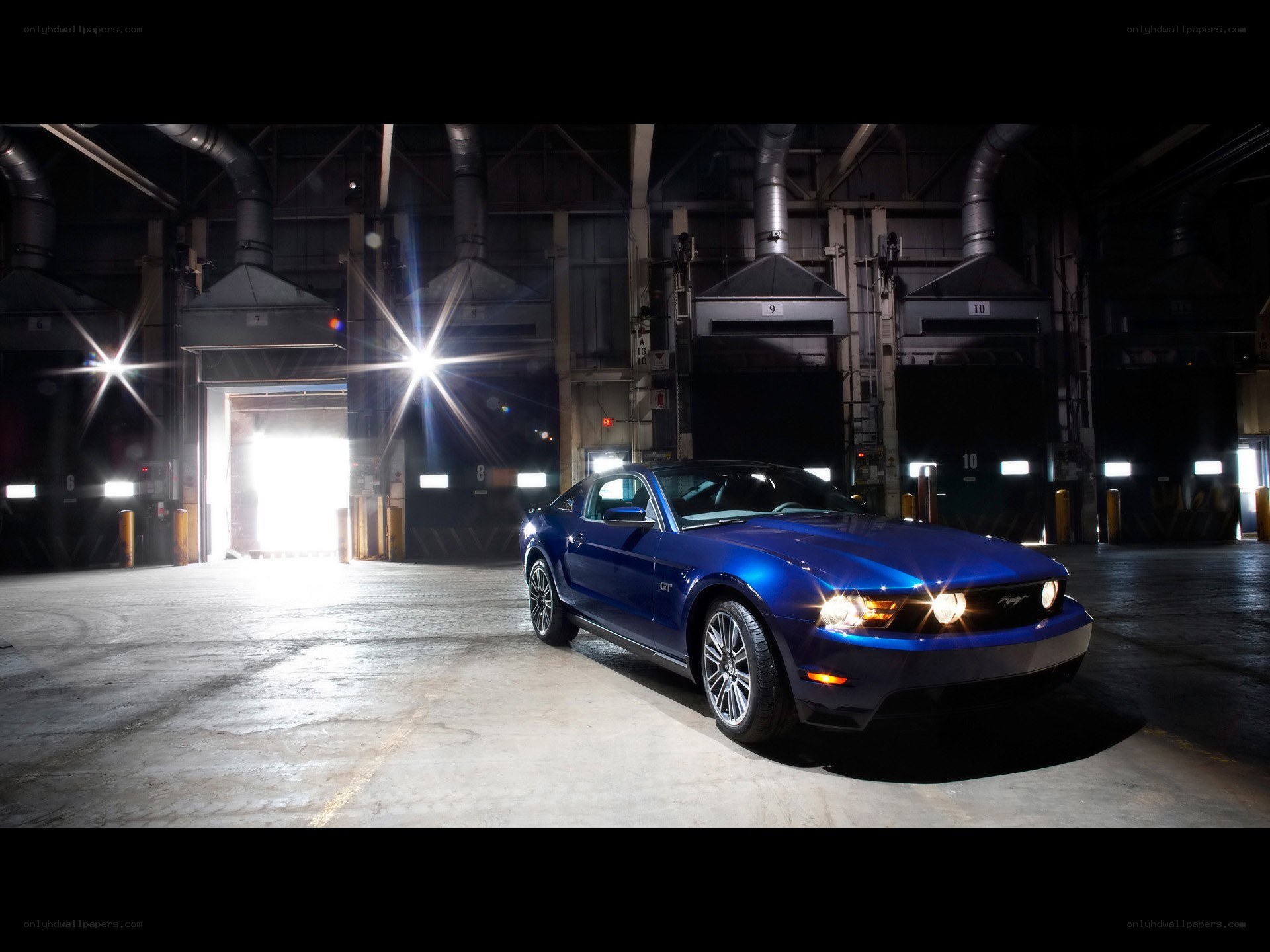 Blue Ford Mustang in a warehouse