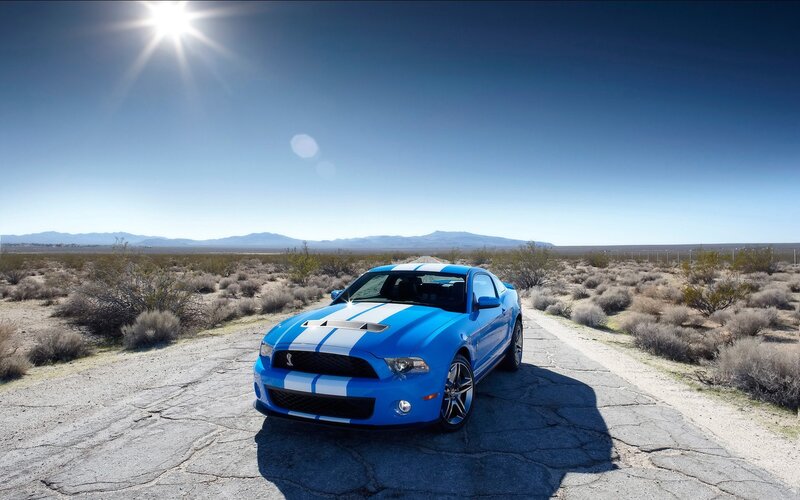 Blue Ford Mustang in desert