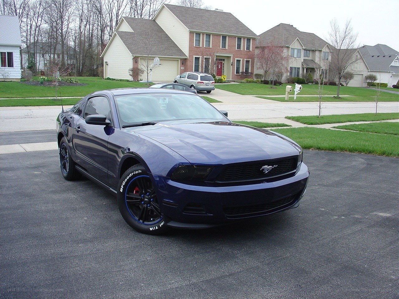 Blue Ford Mustang in driveway