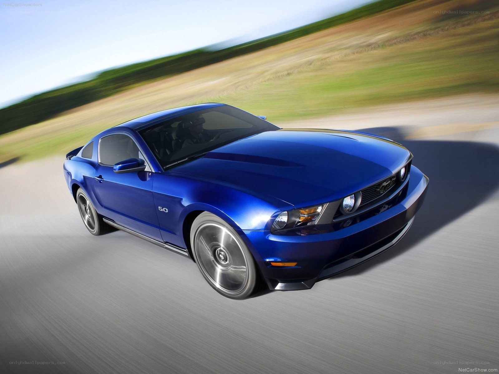 blue ford mustang in motion
