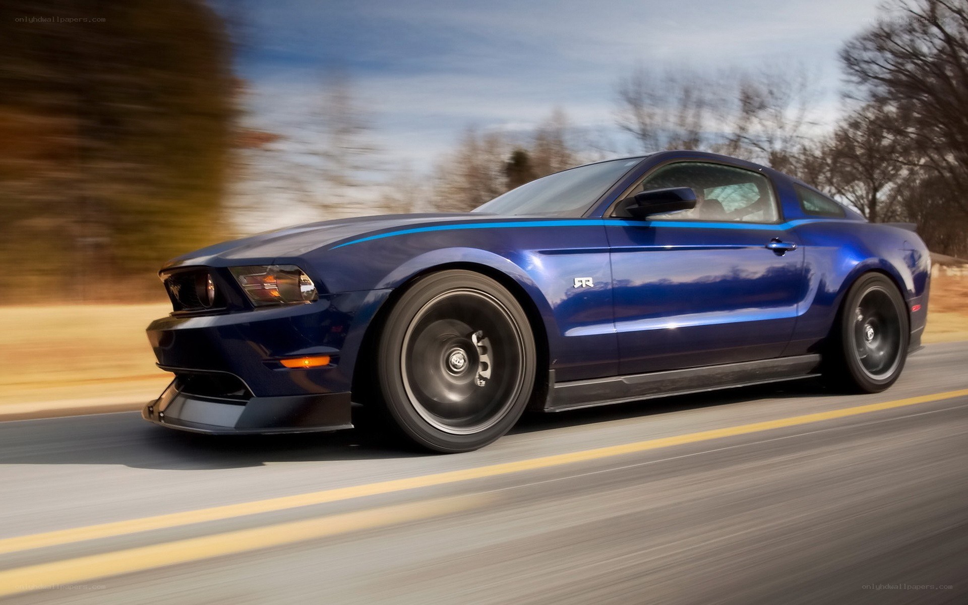 blue ford mustang in motion