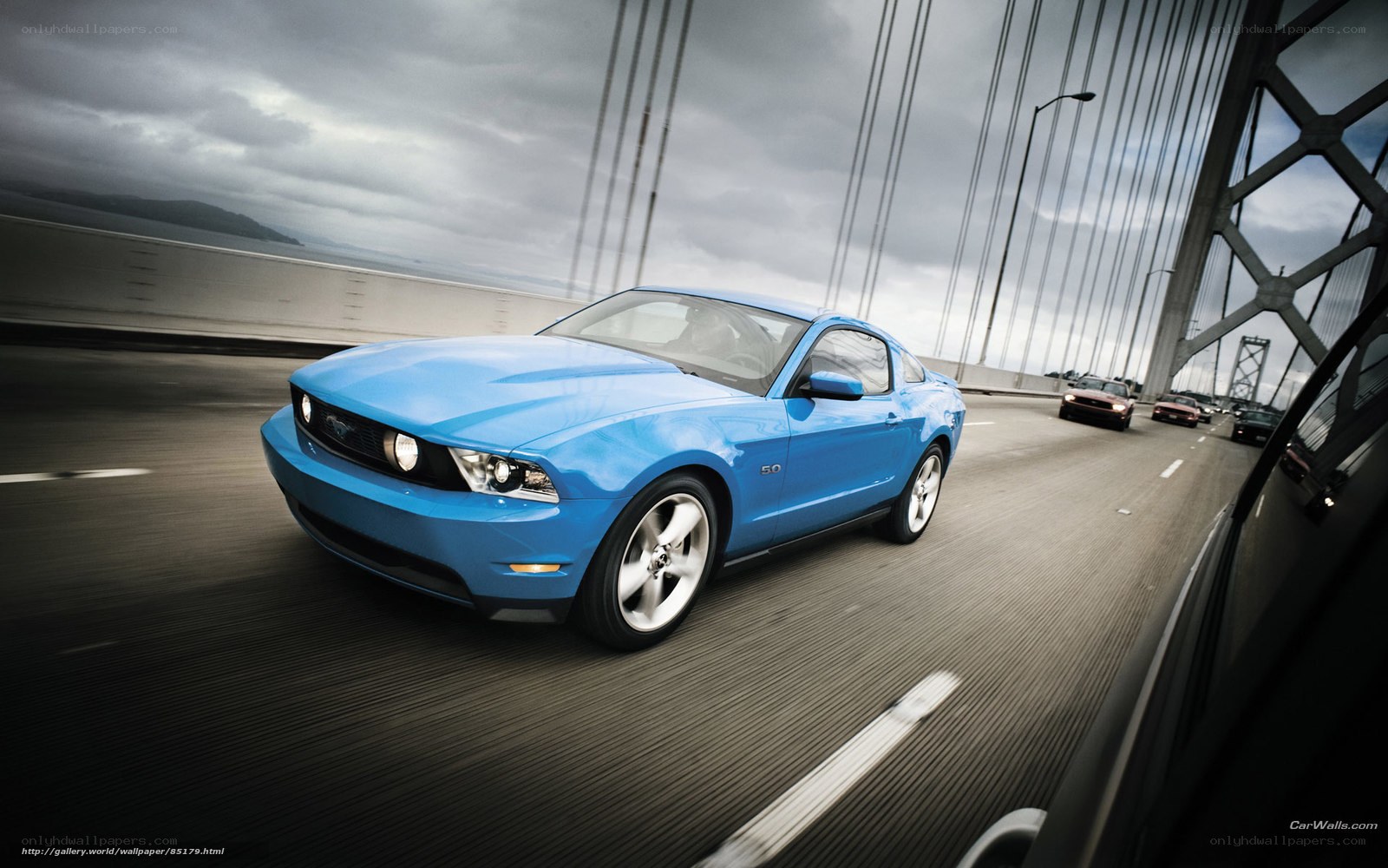 Blue Ford Mustang on a bridge