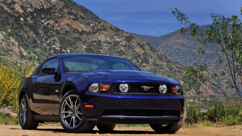 Blue Ford Mustang on a mountain road