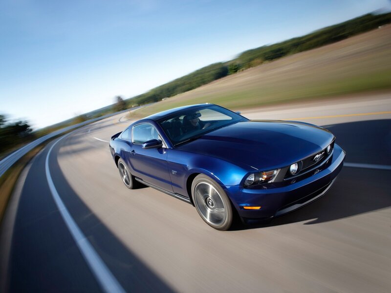 Blue Ford Mustang on a winding road
