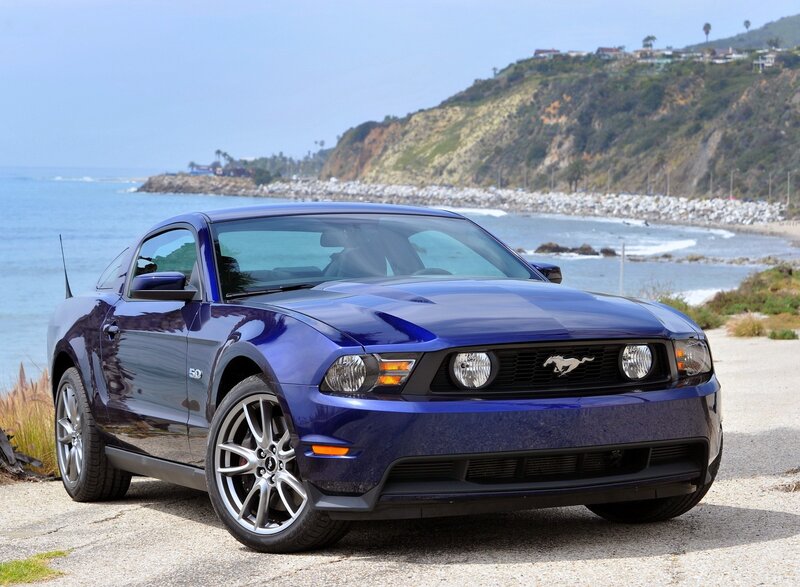 Blue Ford Mustang on coastal road