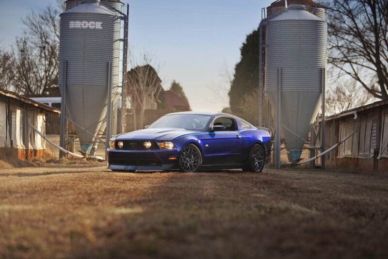 Blue Ford Mustang on farm