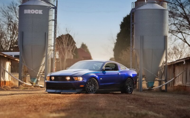 Blue Ford Mustang on farm