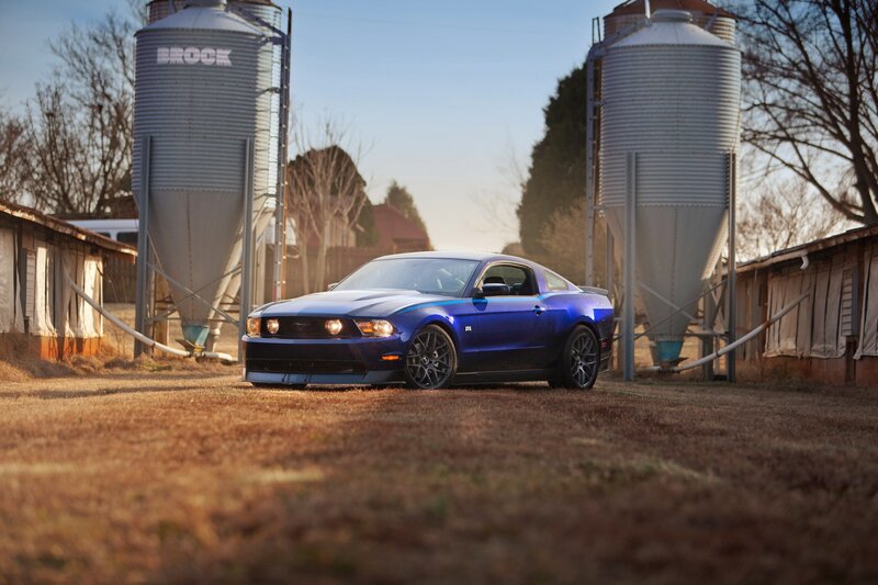 Blue Ford Mustang on farm