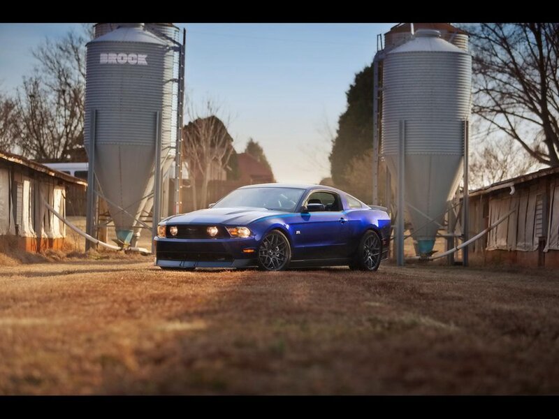 Blue Ford Mustang on farm