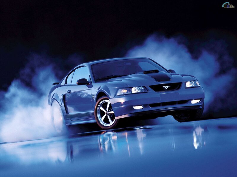 Blue Ford Mustang with smoke