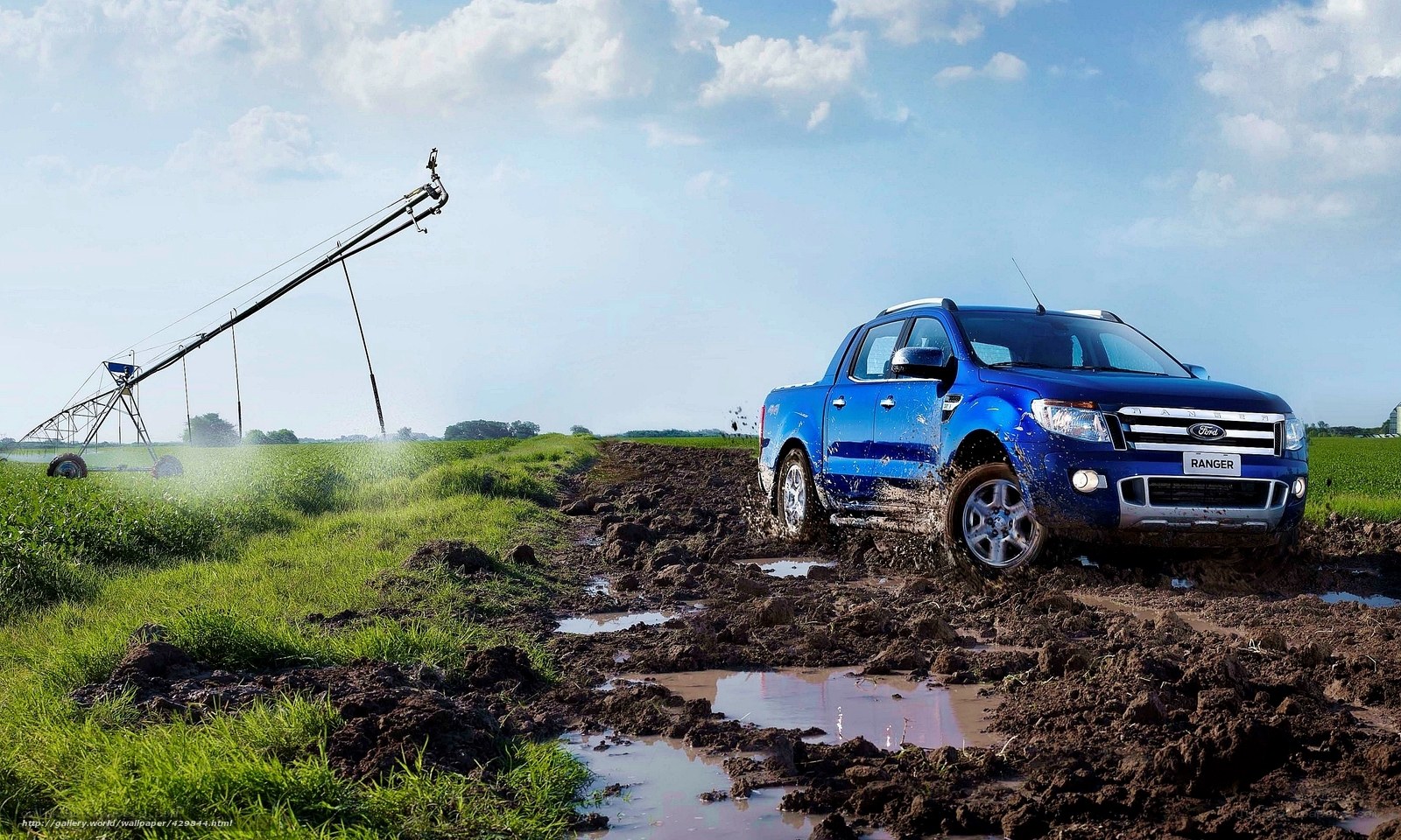 Blue Ford Ranger in muddy field