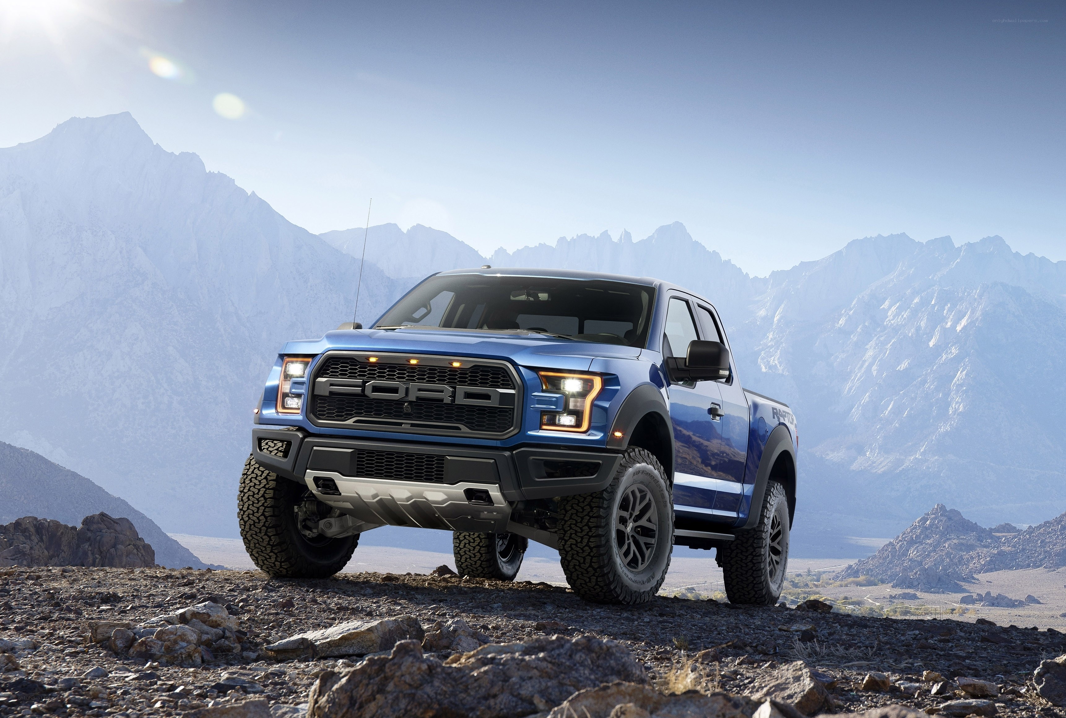 Blue Ford Raptor in mountains