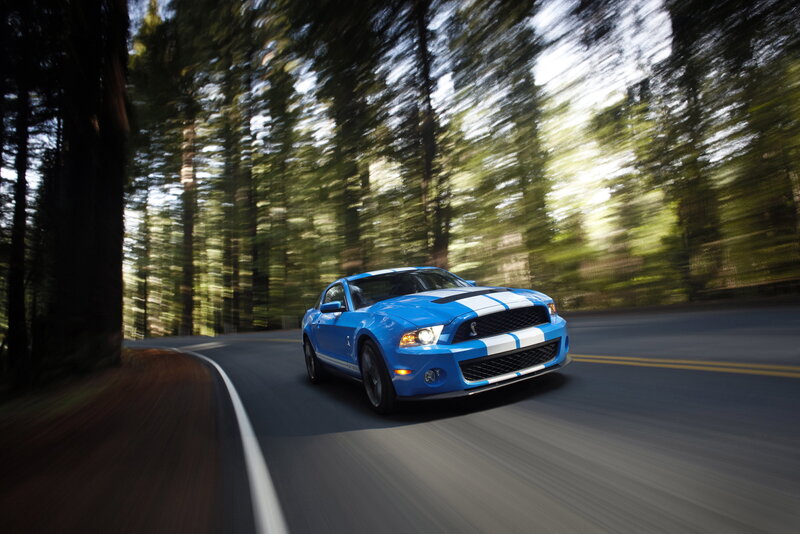 Blue Ford Shelby Mustang on forest road