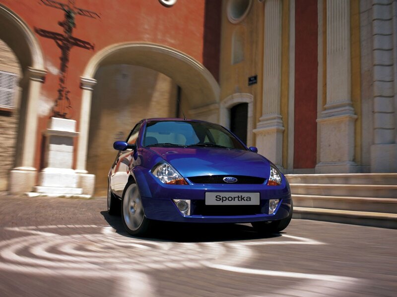 Blue Ford Sportka in a historic town