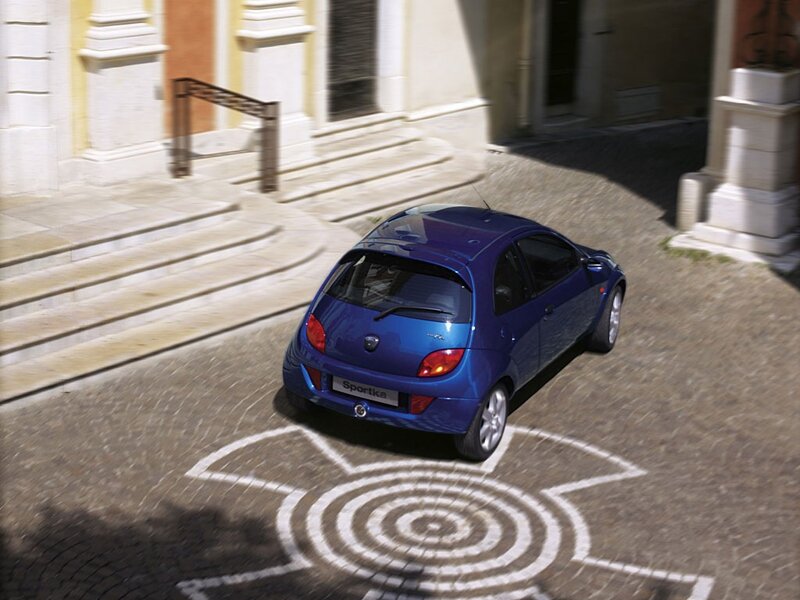 Blue Ford Sportka on cobblestone street