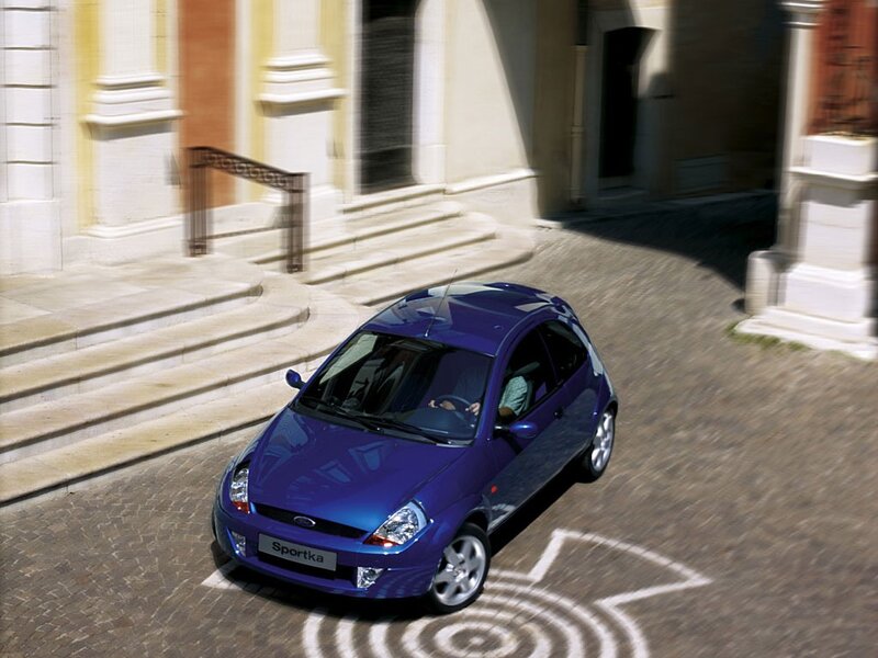 Blue Ford Sportka on cobblestone street