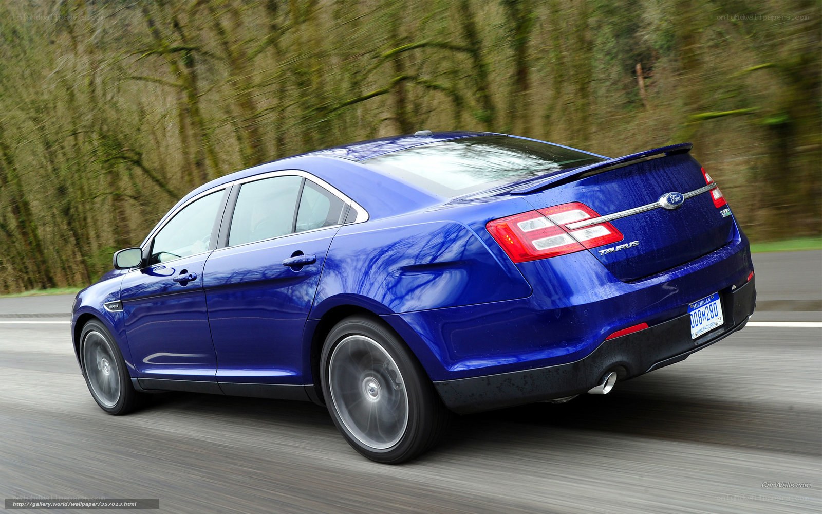 blue ford taurus in motion