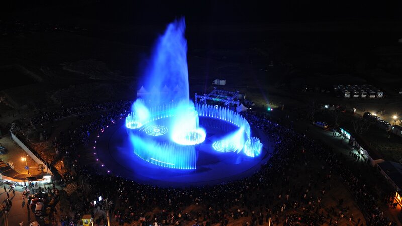 Blue fountain light show at night