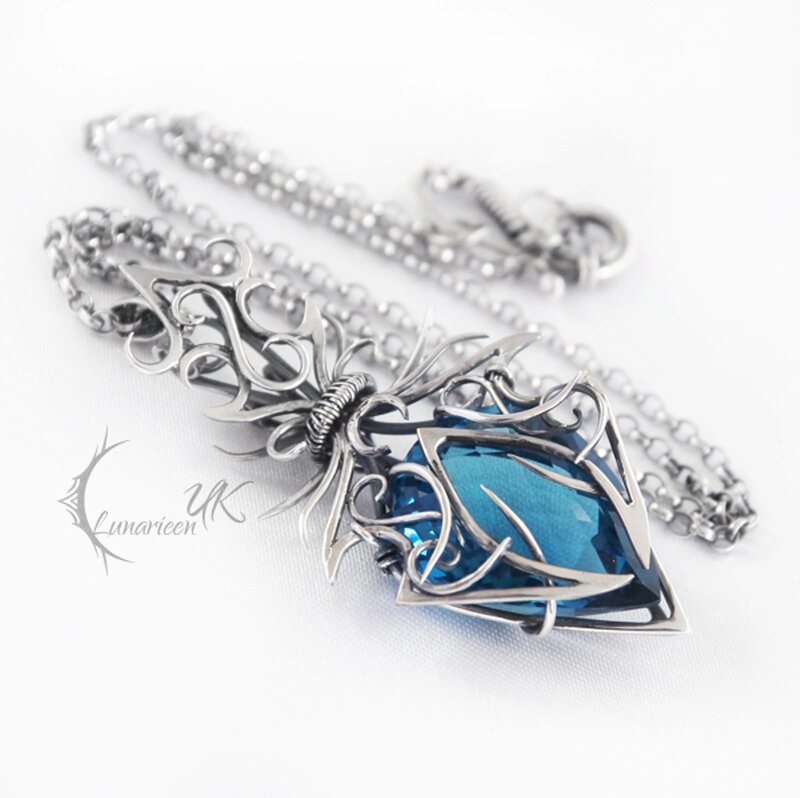 Blue Gemstone Pendant — Silver, Elegant, Photograph