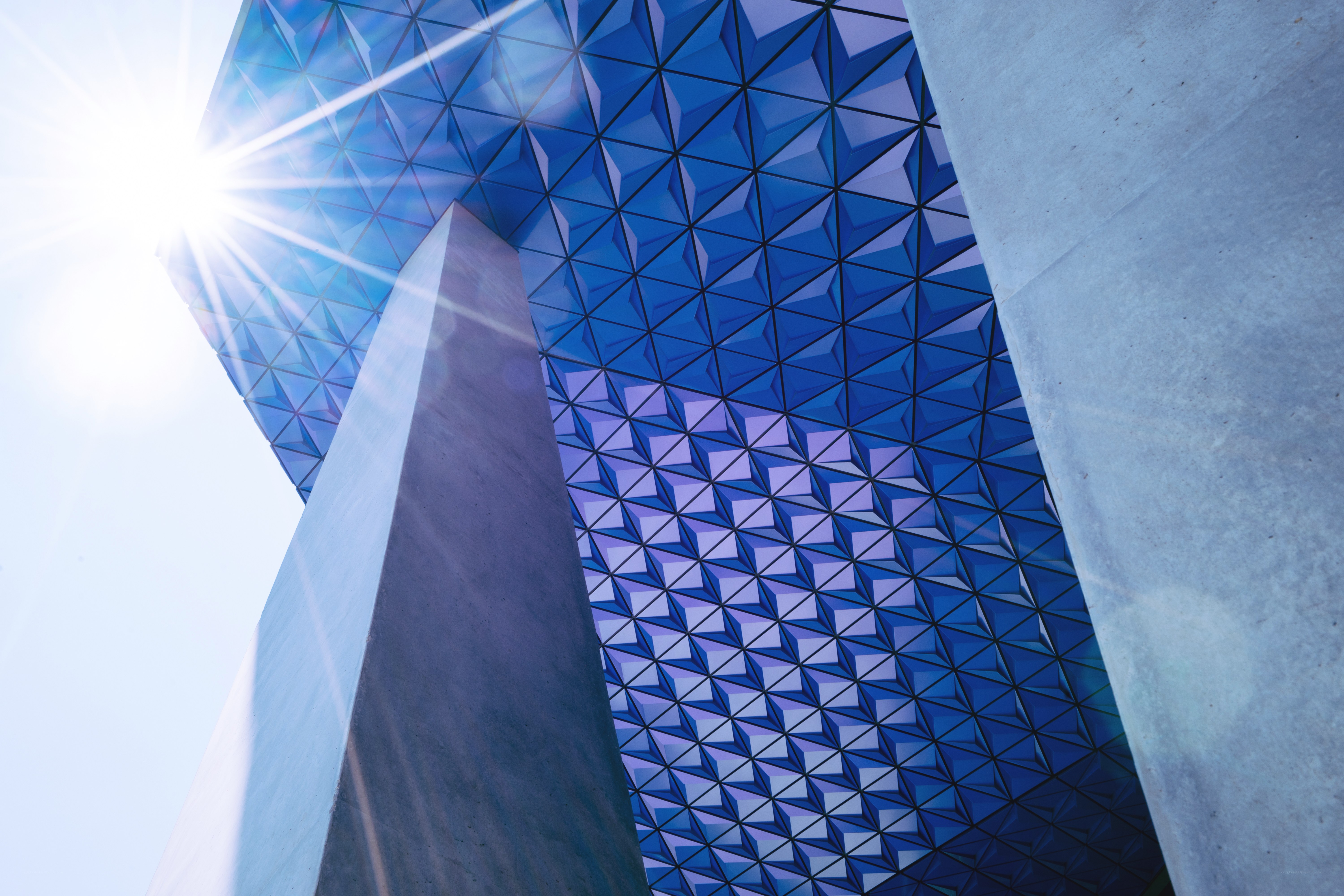 Blue geometric architecture with sunburst
