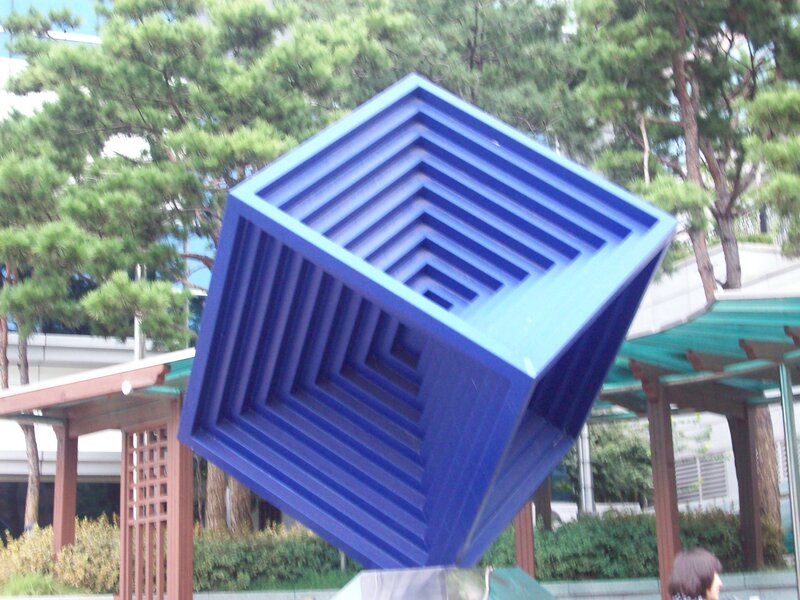 Blue geometric sculpture in park
