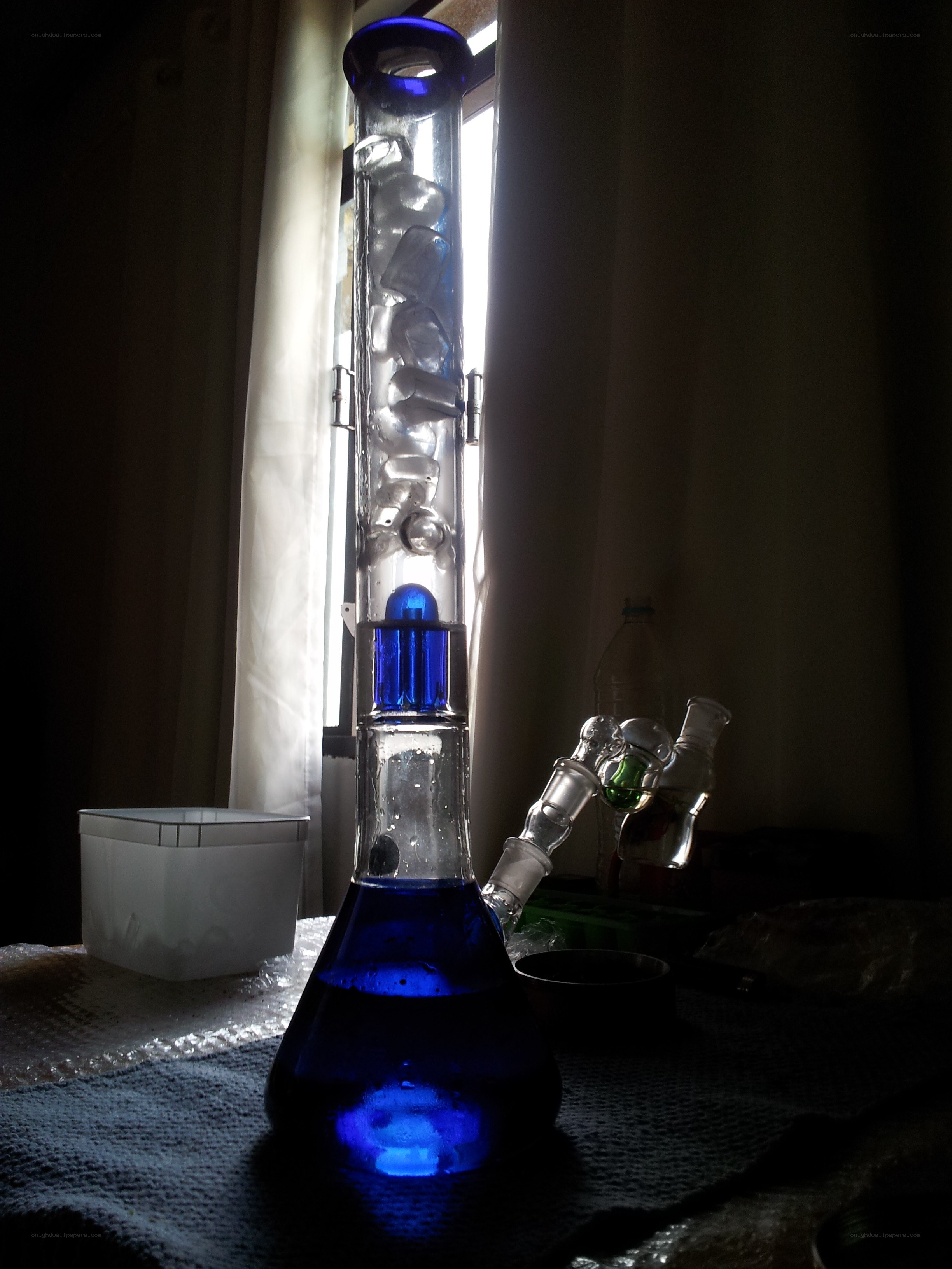 Blue glass bong with ice