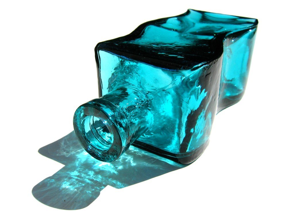 blue glass bottle on white