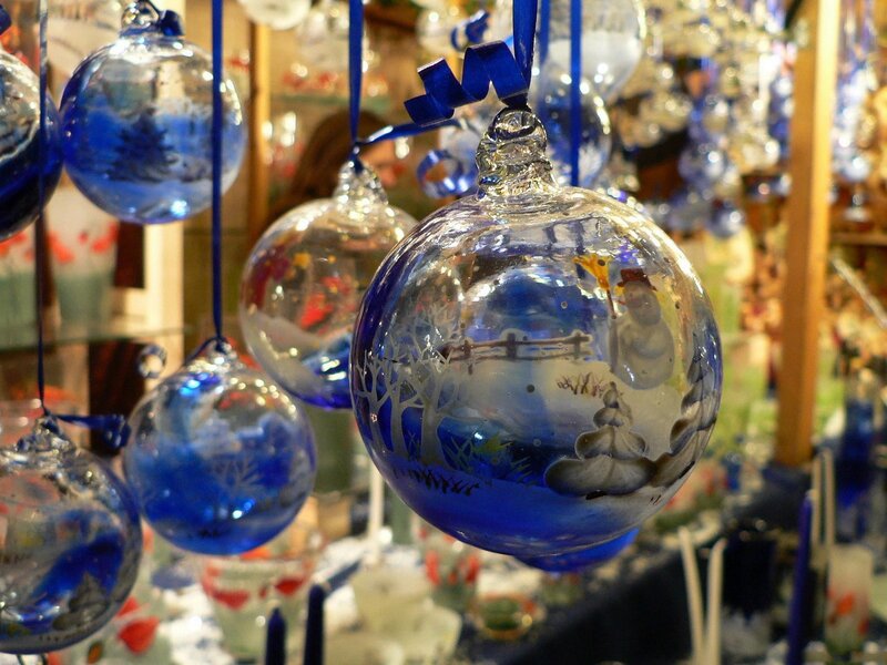 Blue glass ornaments with winter scenes