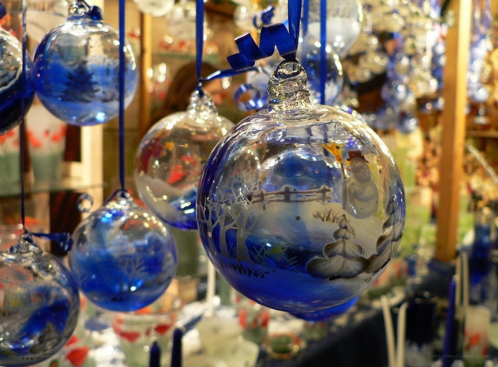 Blue glass ornaments with winter scenes