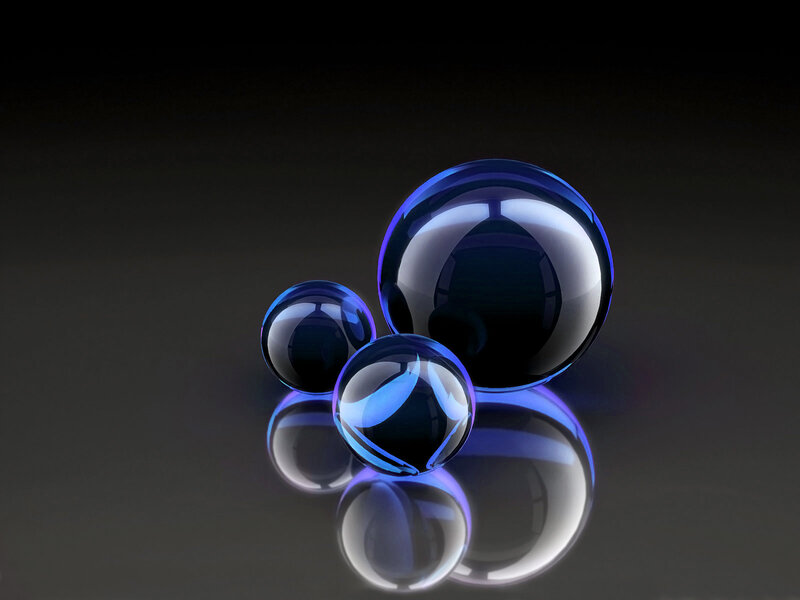 Blue glass spheres on dark surface