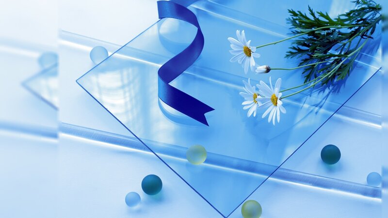 Blue glass with flowers and ribbon