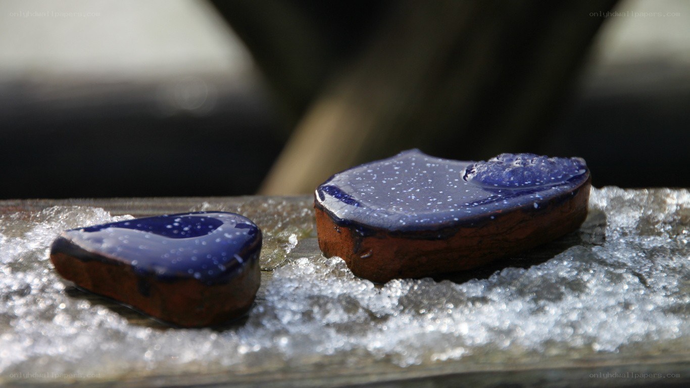 Blue-glazed ceramic pieces on ice