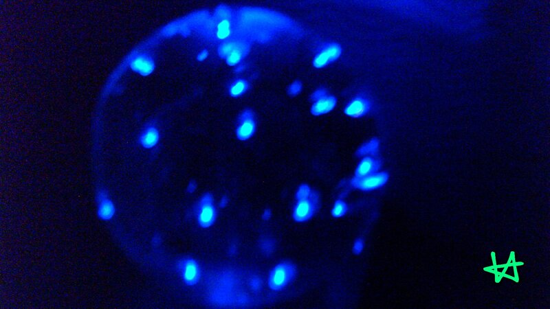 blue glowing particles in dark