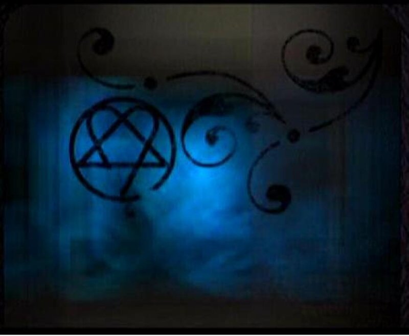 blue glowing symbol on wall