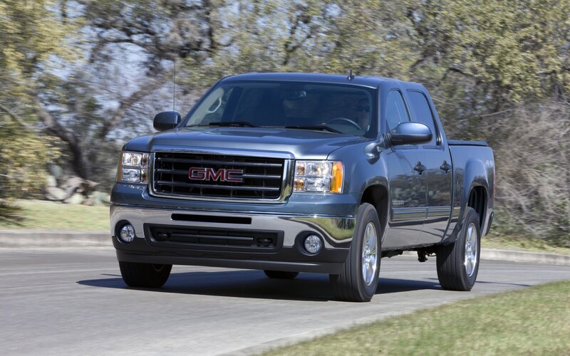 Blue GMC pickup truck on road