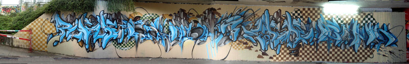 blue graffiti mural under bridge