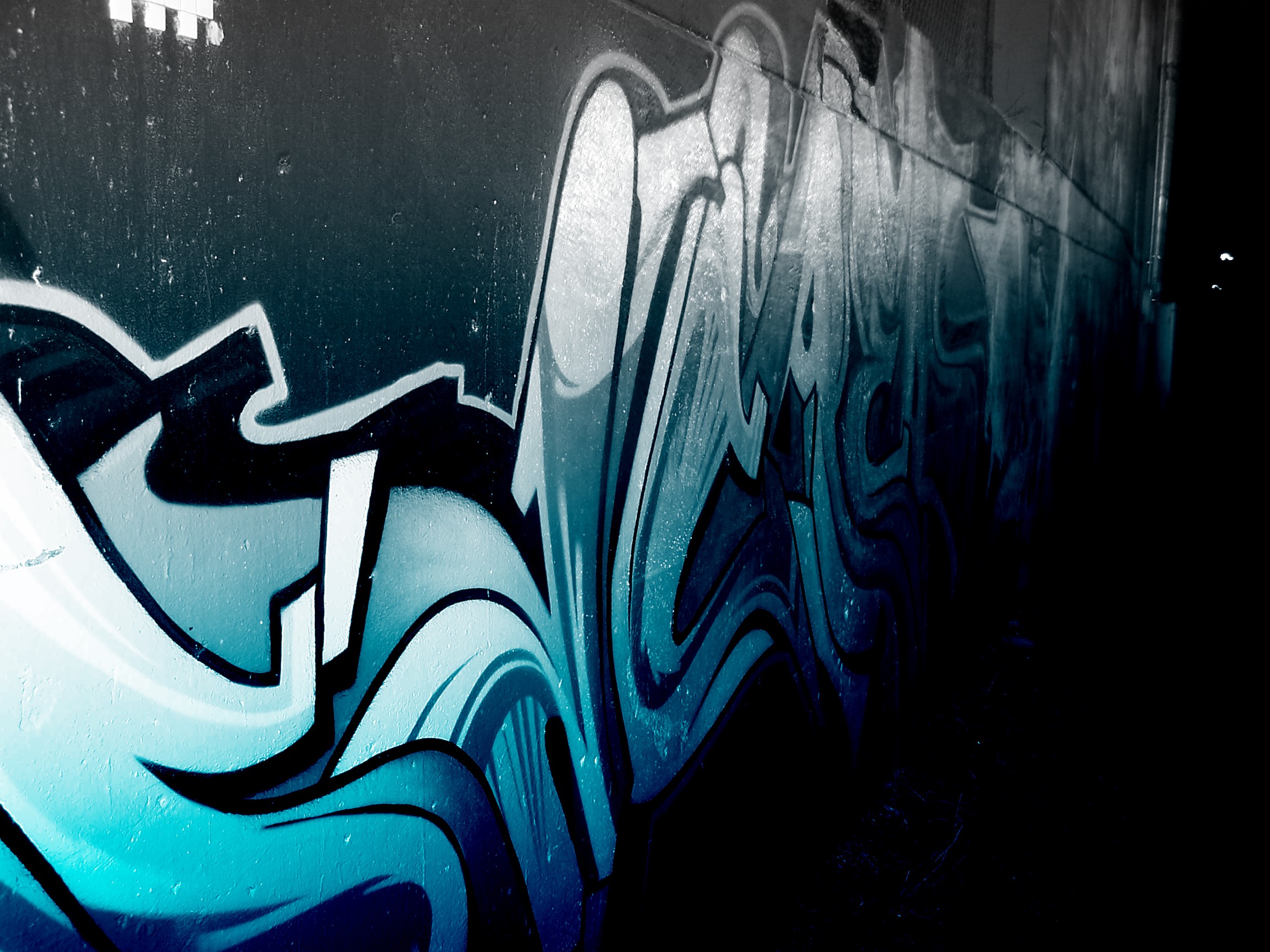 blue graffiti on a wall