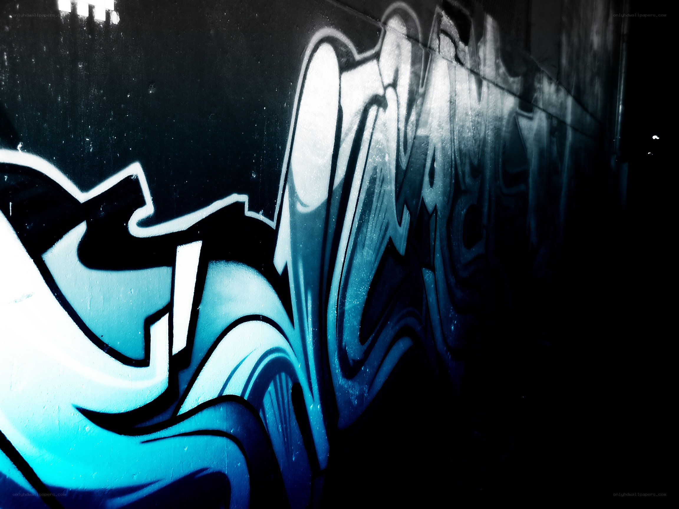 blue graffiti on dark wall