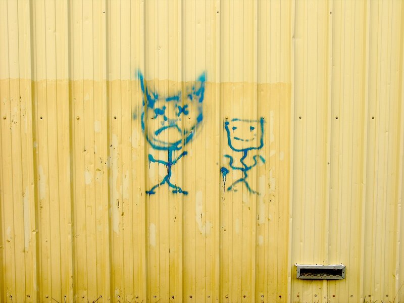 Blue graffiti on yellow wall