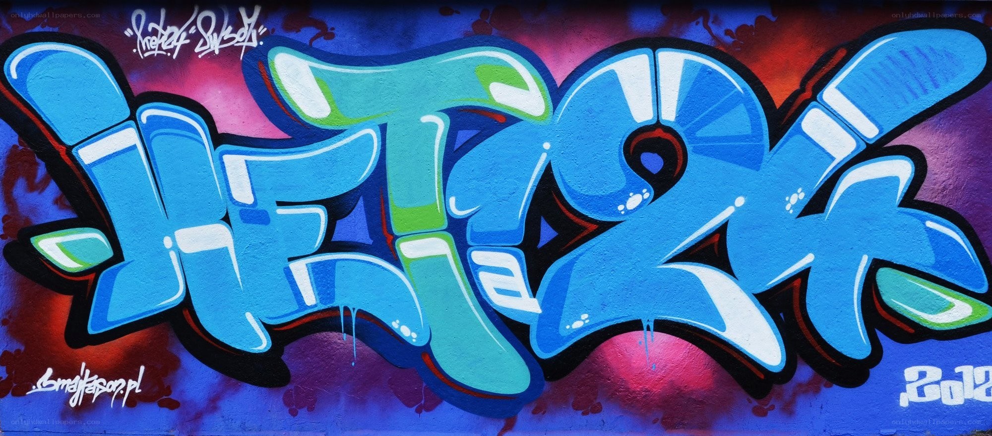 blue graffiti tag on wall