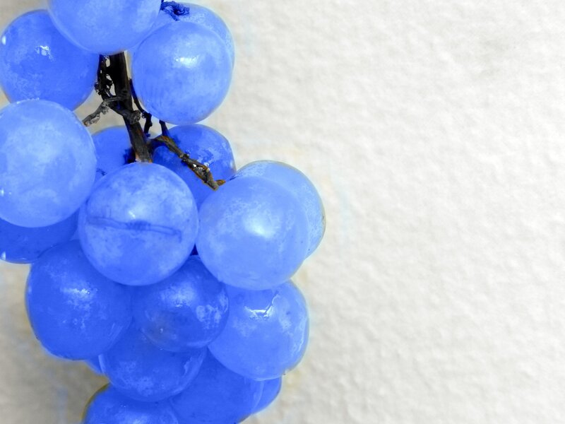 blue grapes on white surface