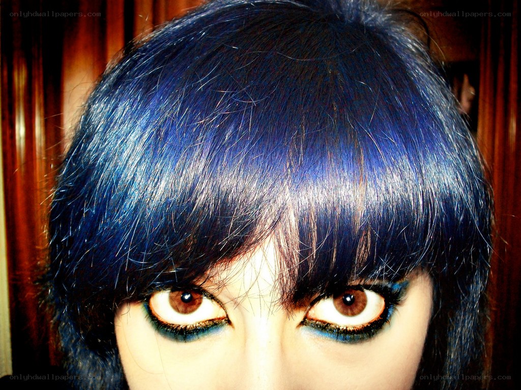 blue hair and dramatic eye makeup