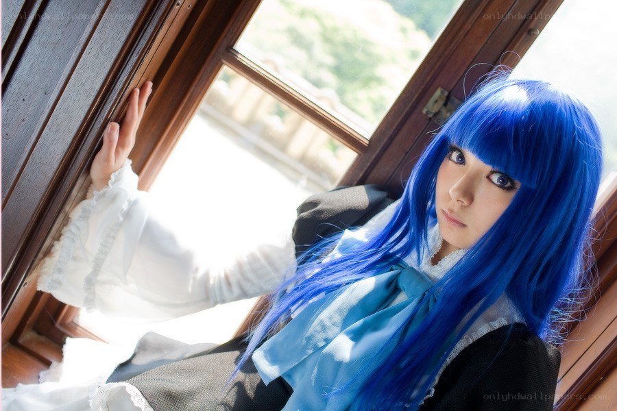 blue-haired cosplayer by window