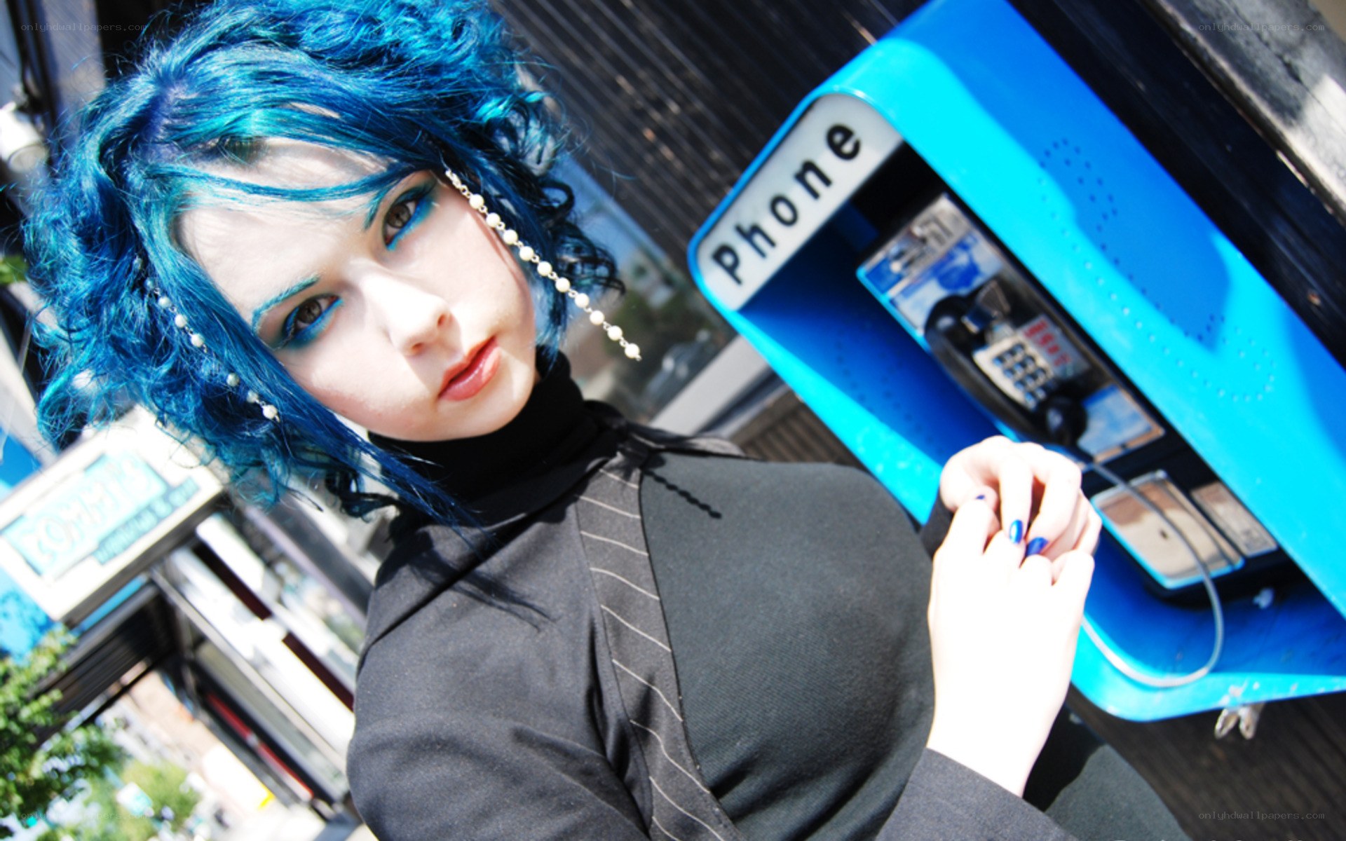 blue-haired person at payphone