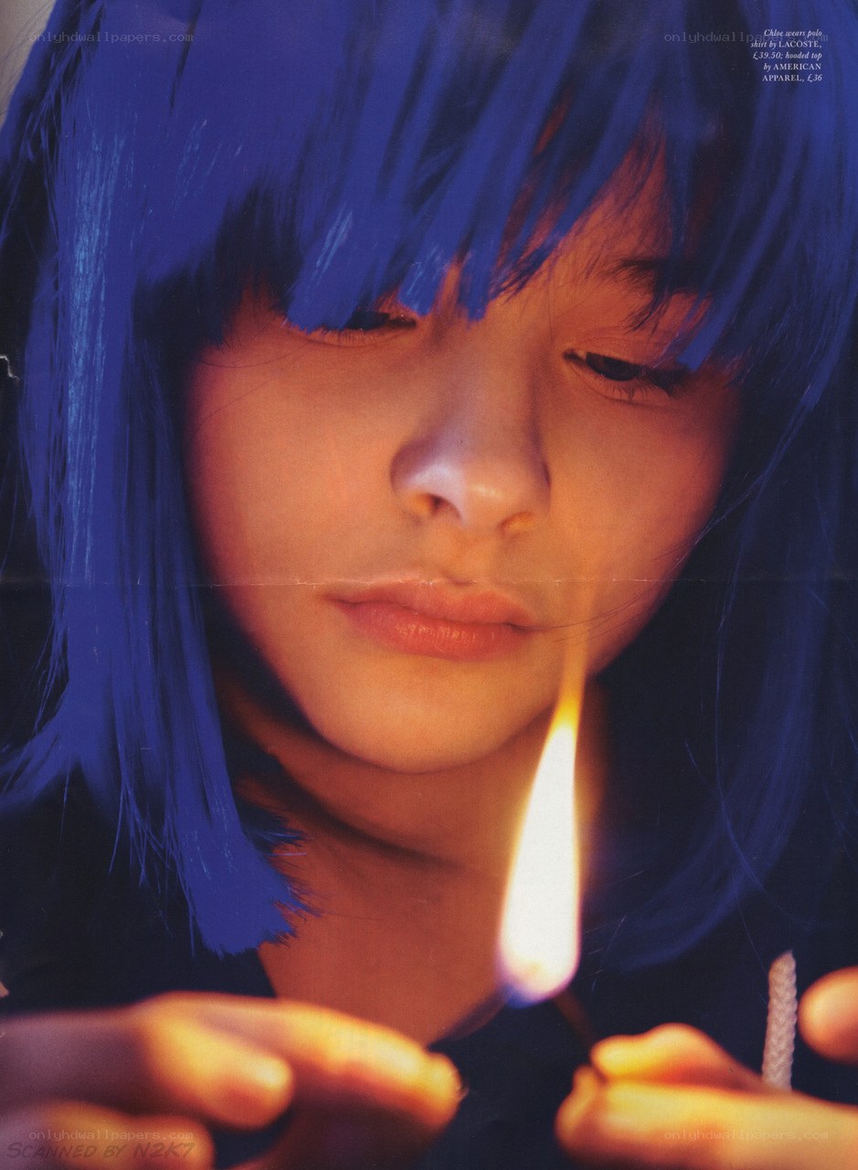 blue-haired person lighting match