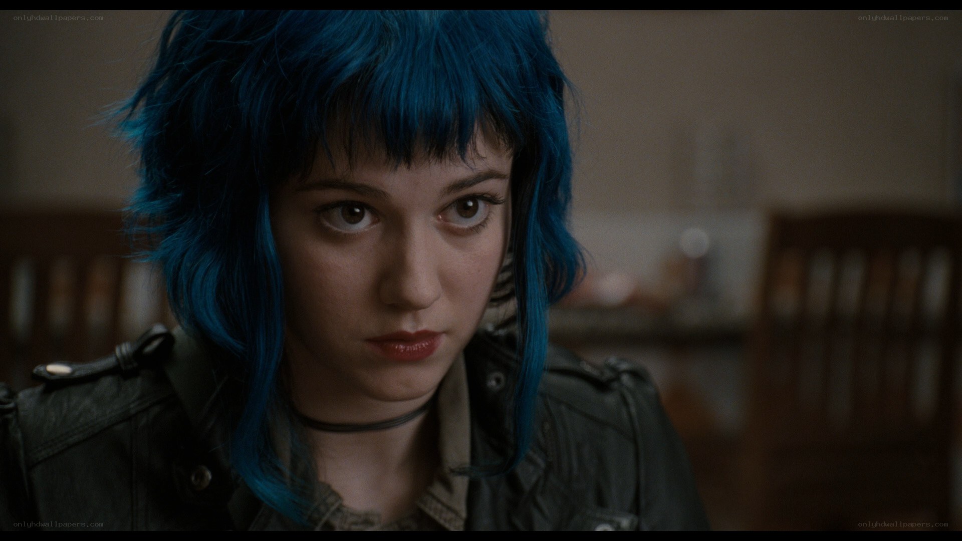 blue-haired woman in leather jacket