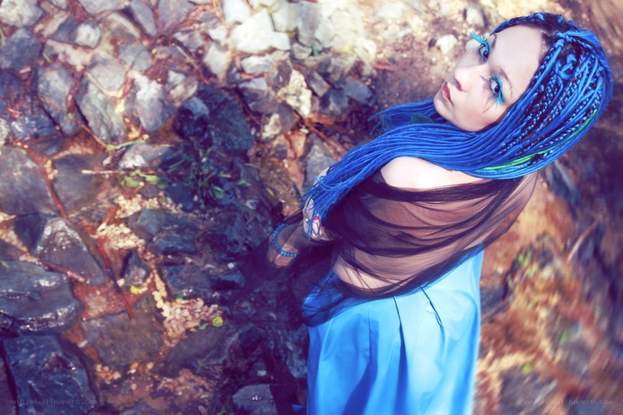 blue-haired woman on rocks