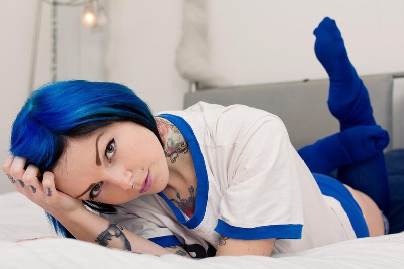 Blue-haired woman with tattoos