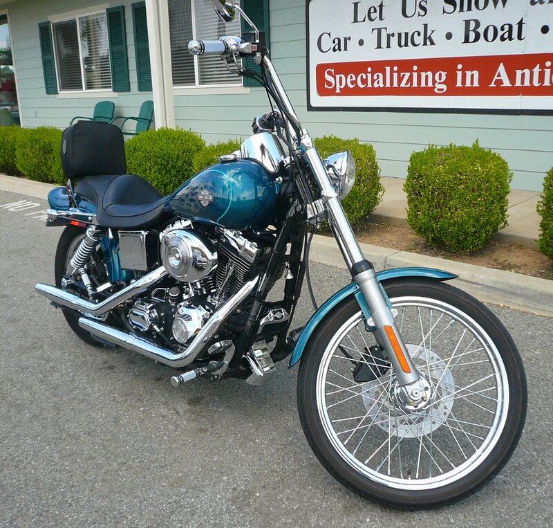 Blue Harley-davidson Motorcycle — Calm, Afternoon, Photograph, Building, Bushes