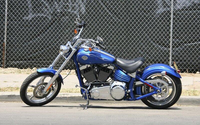 Blue Harley-davidson Motorcycle — Neutral, Afternoon, Photograph, Chain-link Fence, Sidewalk